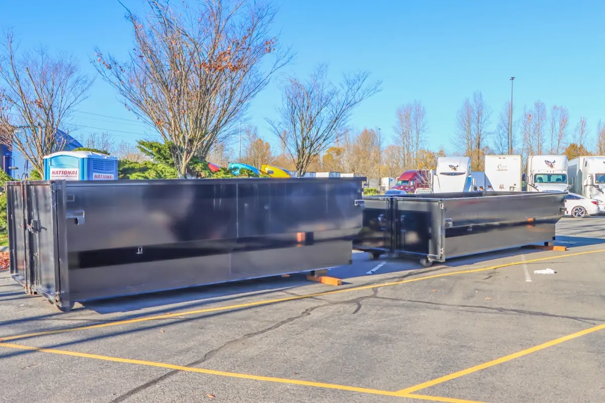 Professional dumpster rental service with roll-off container on residential driveway in Muleshoe